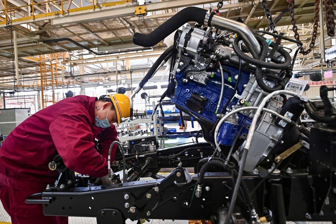 An employee works on a truck assembly line at a factory for Jianghuai Automobile Group Corp in Qingzhou, Shandong province on March 15. Photo: AFP 