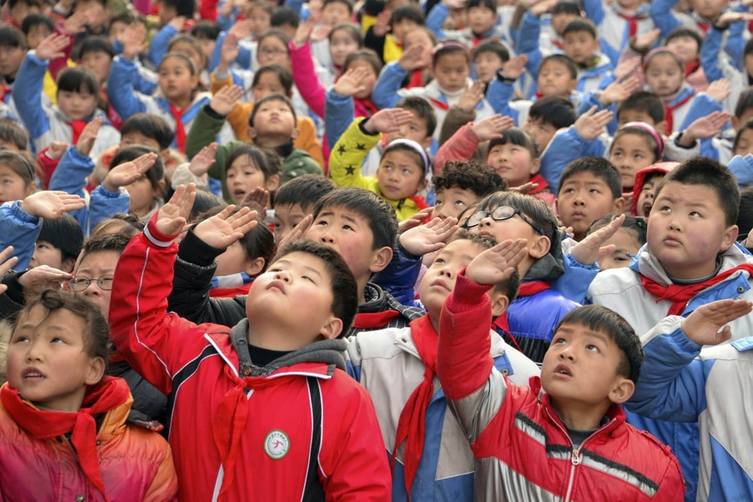 A primary school flag-raising ceremony. Pupils across the country will now face more classes designed to nurture a love for the party. Photo: Reuters
