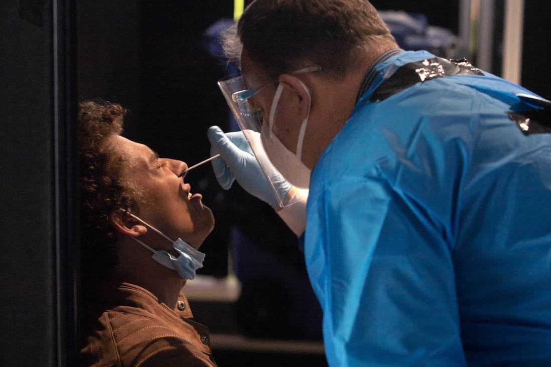 A health worker administers a Covid-19 nasal swab test on a passenger arriving from Cape Town, South Africa, at Amsterdam’s Schiphol Airport on Thursday. Photo: Bloomberg