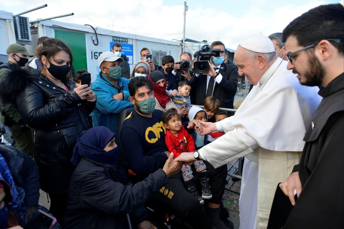 Pope Francis comforts migrants on Lesbos, Greece. Photo: Reuters