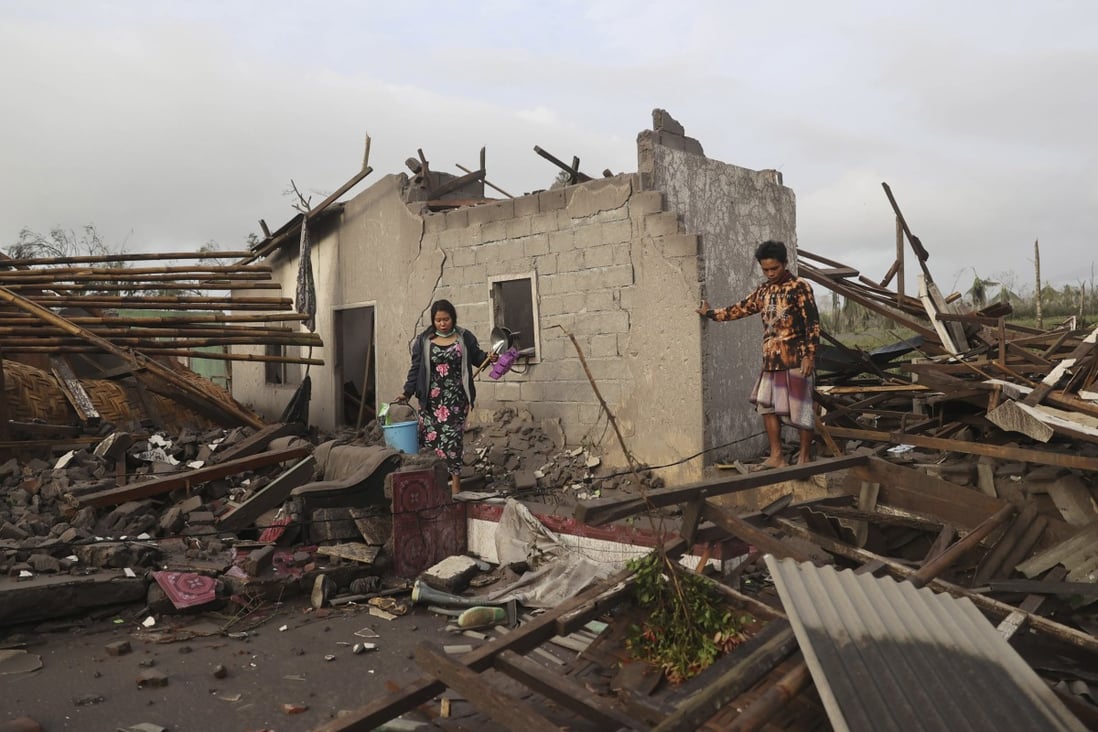 Villagers inspect the damage at their home in an area affected by the eruption of Mount Semeru in East Java. Photo: AP