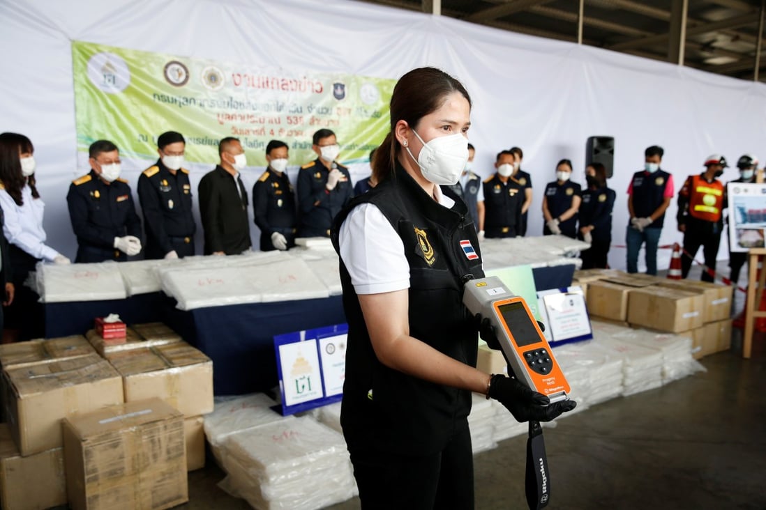 Thai authorities show the result of a machine test as they seized  crystal meth in Bangkok, Thailand on Saturday. Photo: Reuters 
