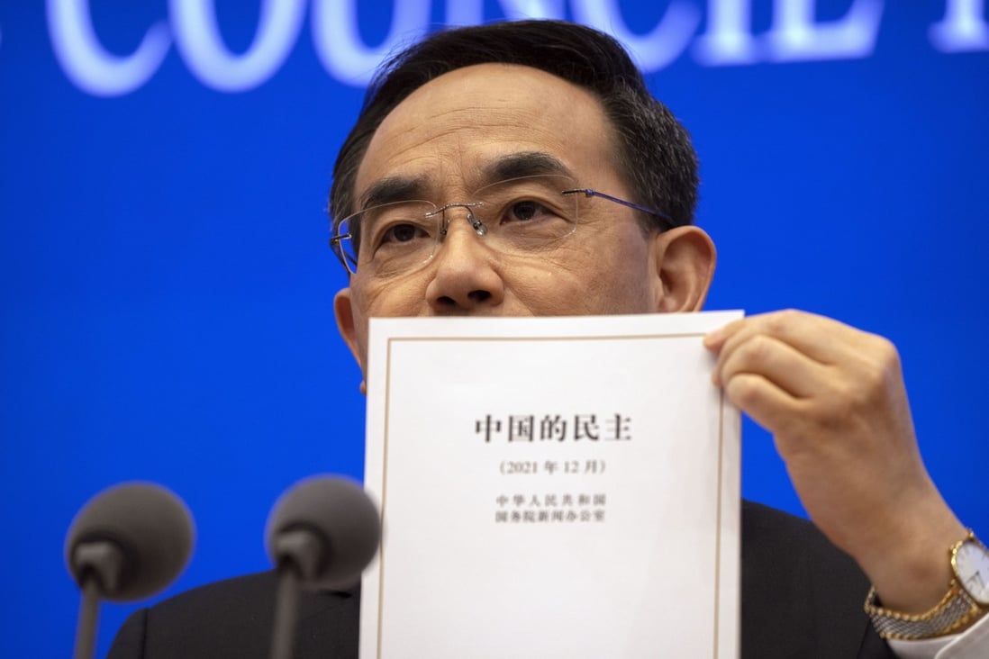 Xu Lin, vice-minister of the publicity department of the Communist Party’s Central Committee, holds up a copy of the white paper on democracy released last week, at a press conference in Beijing on December 4. Photo: AP