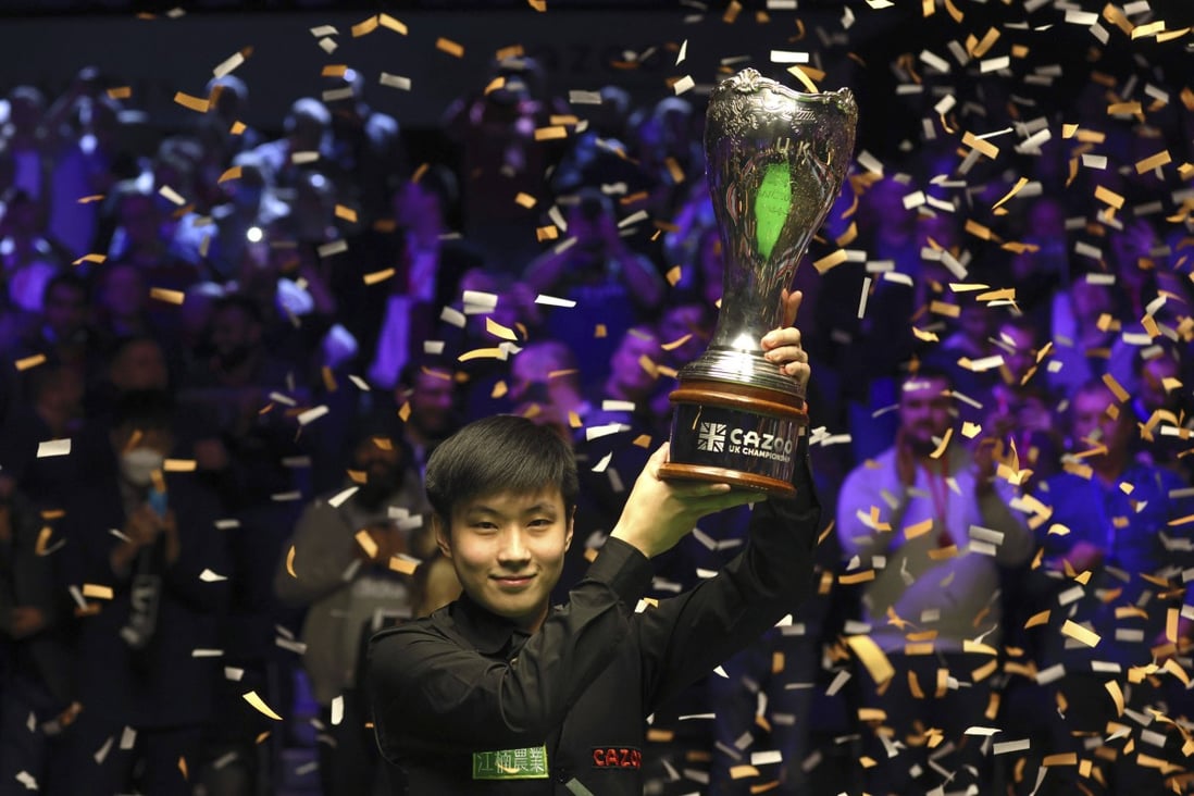 Zhao Xintong holds the trophy after winning the the UK Championship at the York Barbican. Photo: AP