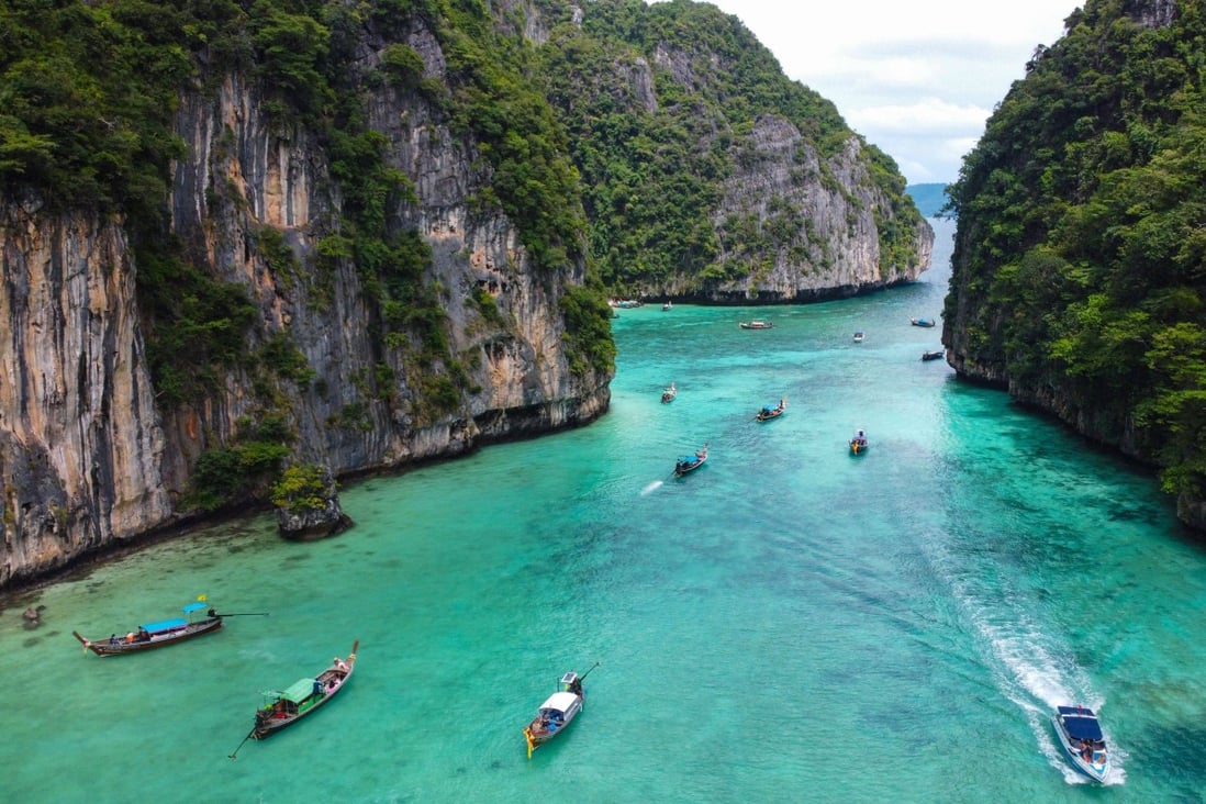 Tourists in longtail boats approach Ko Phi Phi Leh in Thailand. Photo: AFP