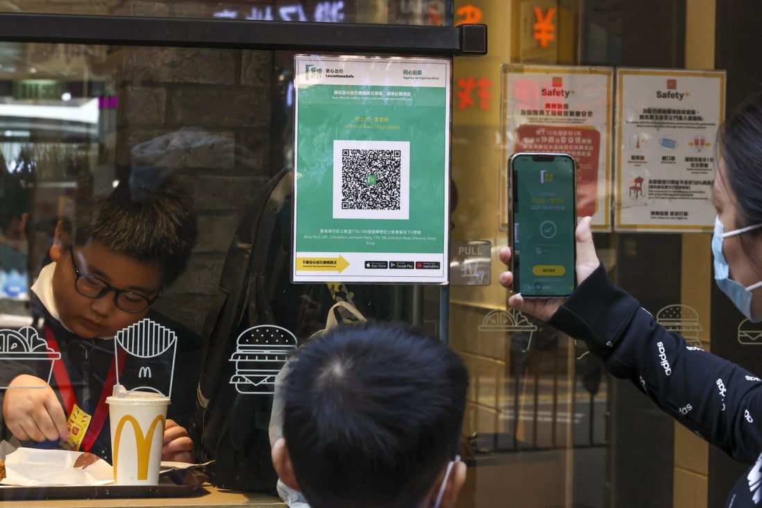 Residents use Hong Kong’s ‘Leave Home Safe’ app before entering a restaurant. Photo: K. Y. Cheng