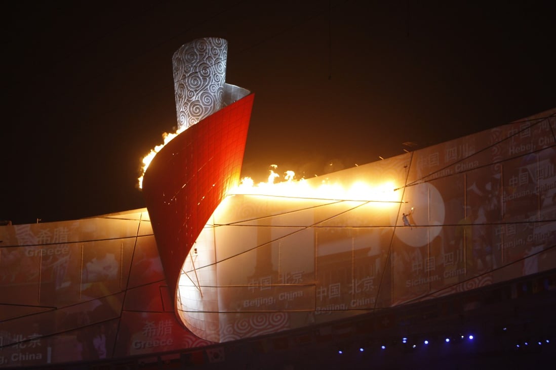 The Olympic flame is lighted during the opening ceremony for the Beijing Summer Games, on August 8, 2008. Photo: Robert Ng