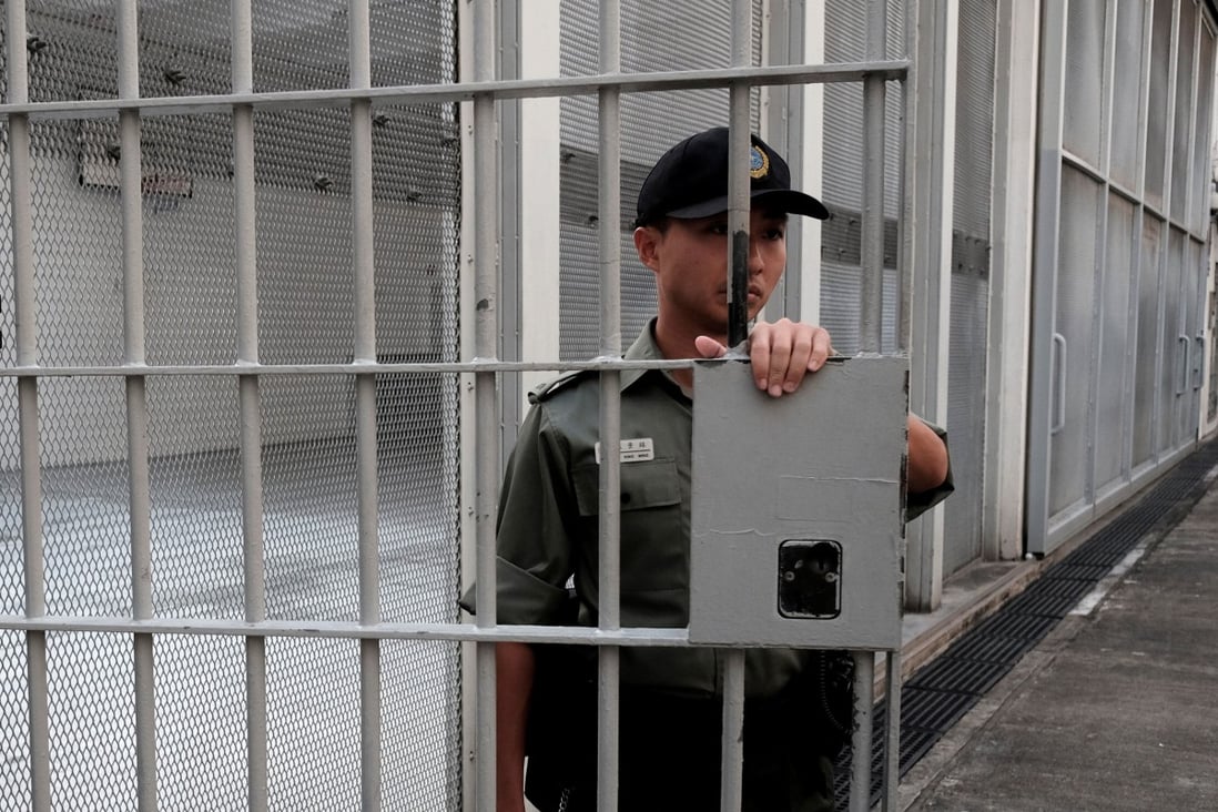 A Correctional Services Department officer holds a gate at Lai Chi Kok Reception Centre, a maximum security institution, in 2018. Photo: Reuters
