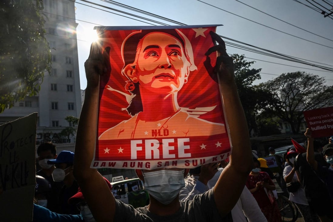 Protesters in Myanmar hold portraits of deposed leader Aung San Suu Kyi during an anti-coup demonstration in Mandalay earlier this year. Photo: AFP