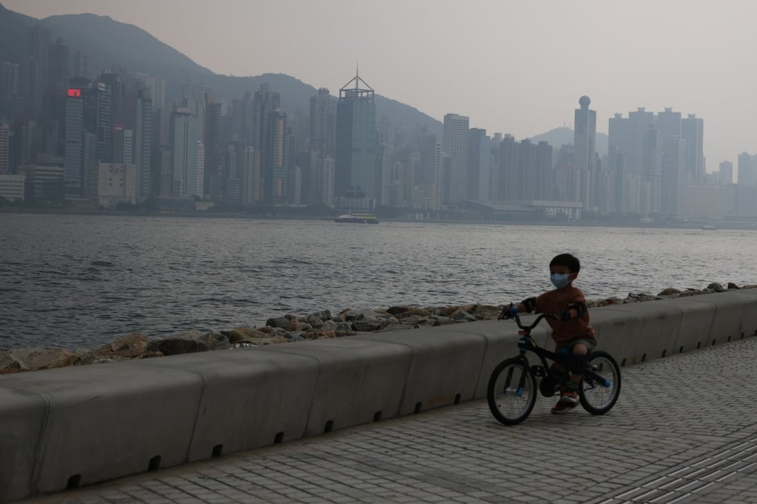 A child rides a bicycle along the West Kowloon waterfront on June 6, amid higher than normal  levels of pollution. Photo: May Tse