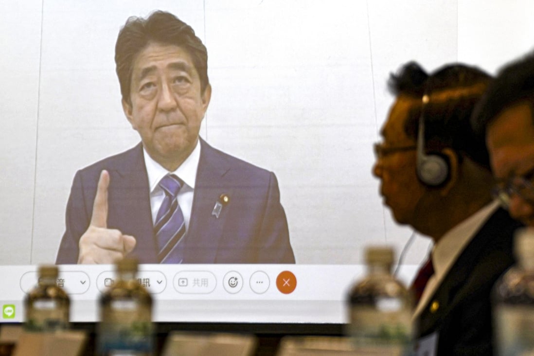 Shinzo Abe appears on a screen during a meeting in Taipei on December  1. Beijing lashed out at Abe after the former Japanese prime minister warned of the serious security and economic consequences of any mainland military action against the self-ruled island. Photo: Kyodo