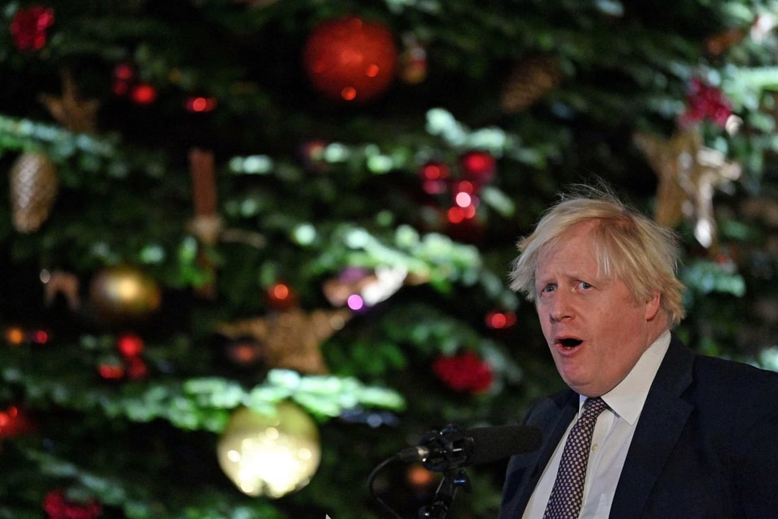 Britain’s Prime Minister Boris Johnson in front of the Downing Street Christmas tree. Photo: AFP