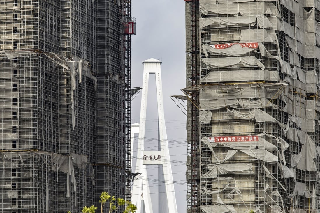Scaffolding netting damaged by Typhoon In-Fa shrouds buildings at a residential development under construction in Shanghai on July 29. Chinese policymakers are walking a tightrope as they seek to balance the need to rein in leverage in the property sector with the fallout of the near-collapse of China Evergrande Group and other developers. Photo: Bloomberg