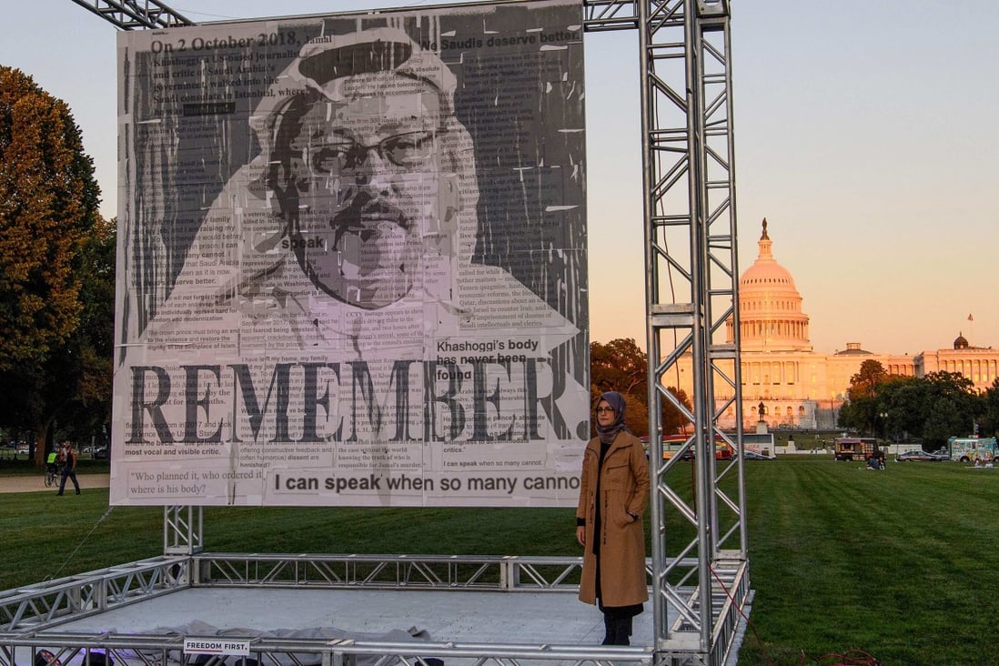 Turkish writer Hatice Cengiz, fiancée of Saudi journalist Jamal Khashoggi, poses next his portrait after unveiling it on the National Mall in Washington in October. Photo: AFP