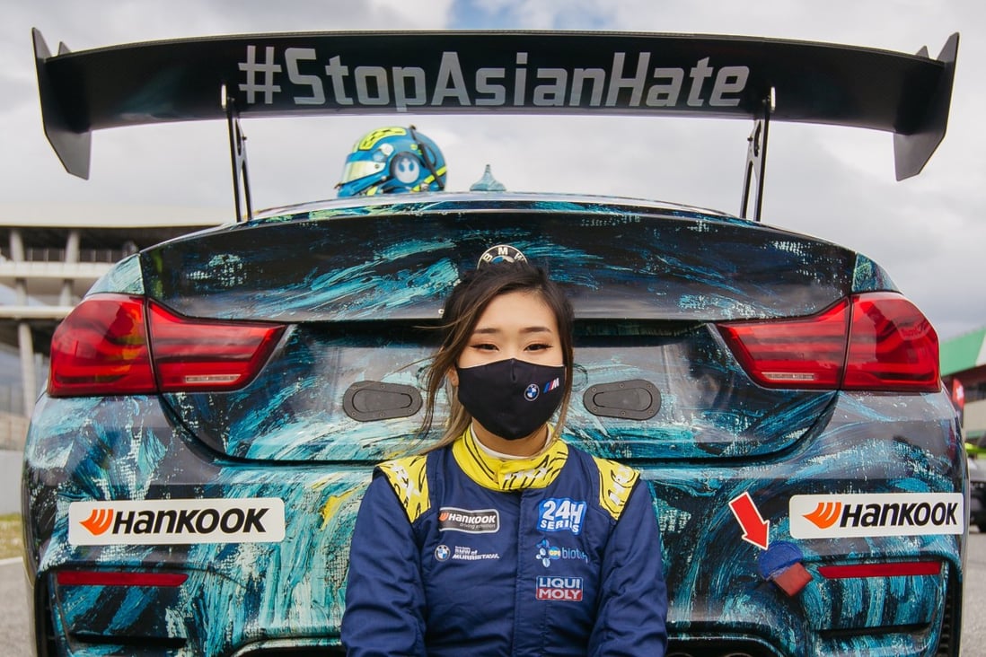 Professional racing car driver Samantha Tan with her new BMW M4 GT4 endurance race car with the hashtag #StopAsianHate printed on its rear wing. Photo: ST Racing   