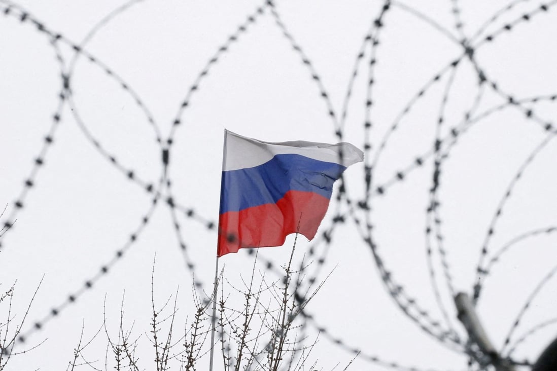 The Russian flag is seen through barbed wire as it flies on the roof of Moscow’s embassy in Kyiv, Ukraine in March 2018. Photo: Reuters