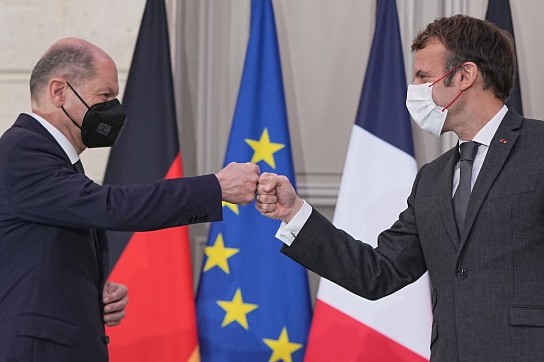 German Chancellor Olaf Scholz (left) and French President Emmanuel Macron fist bump at the end of their joint press conference at the Elysee Palace on Friday. Photo: dpa