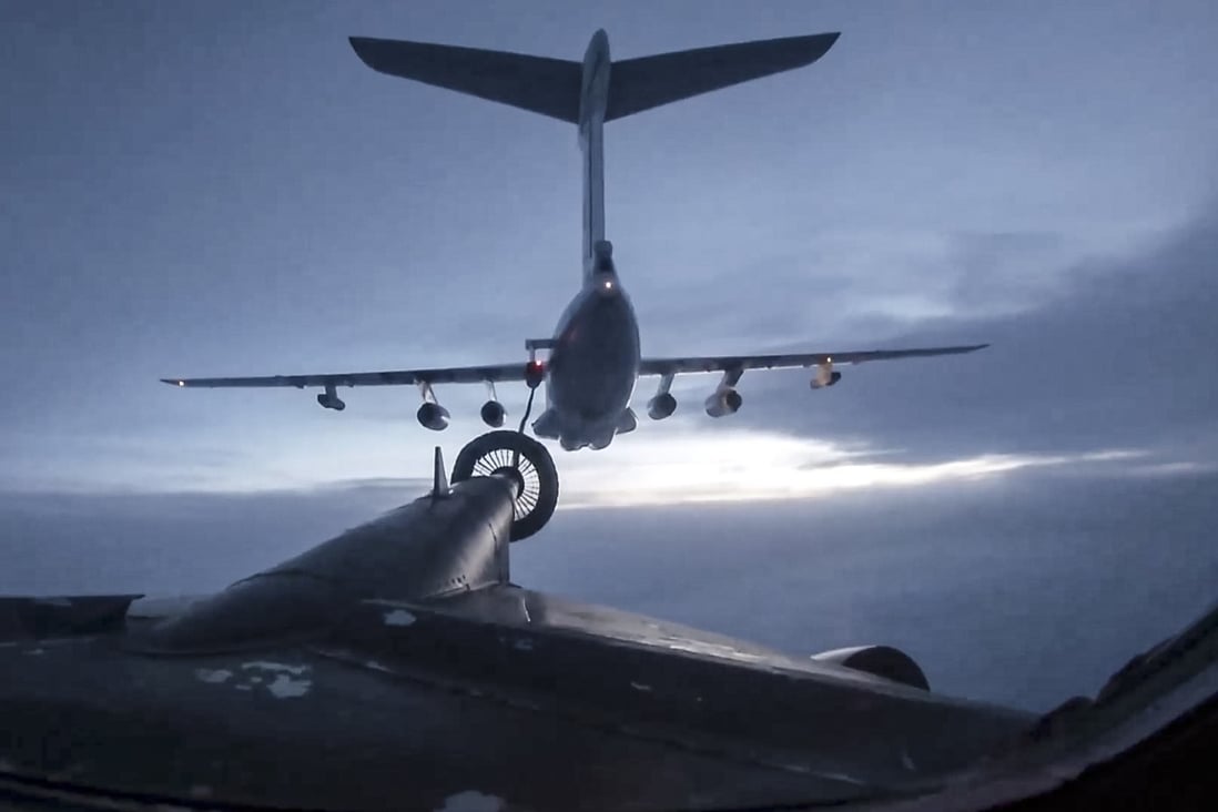 In this photo taken from video released by the Russian Defence Ministry Press Service, a Russian Il-76 air tanker, top, is refuelling a Russian Tu-95MS strategic bomber of the Russian Aerospace Forces, during an aerial patrol over the waters of the Sea of Japan and the East China Sea on November 19. Photo: Russian Defence Ministry Press Service via AP