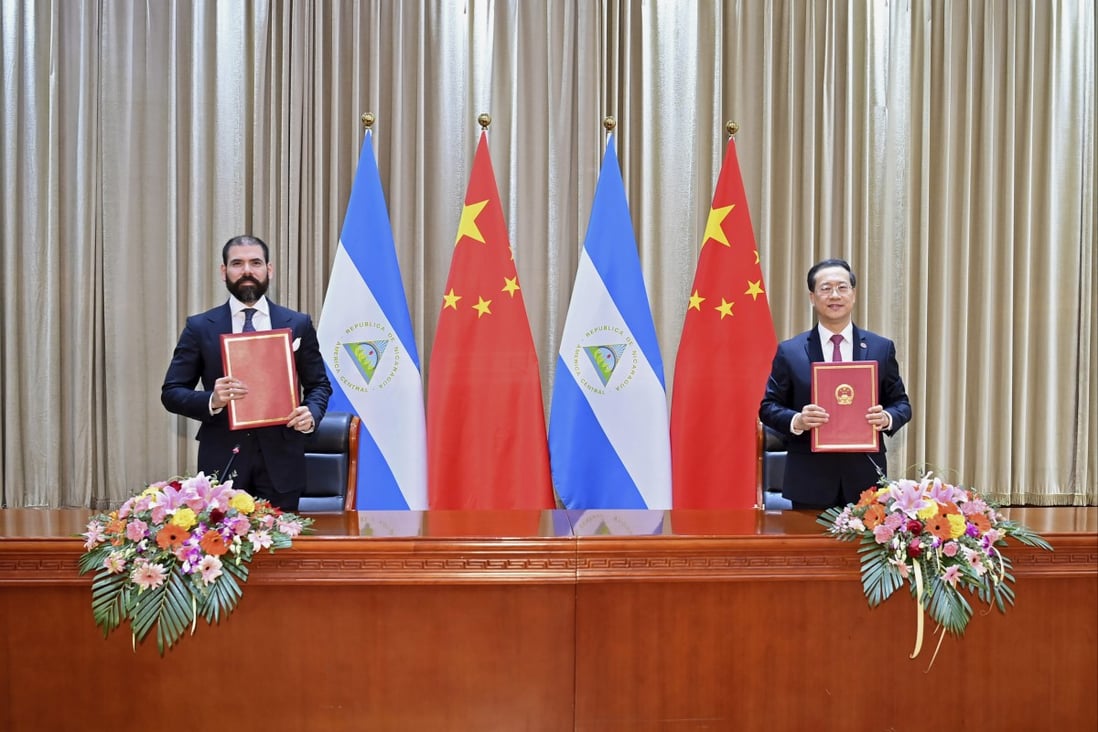 Laureano Ortega Murillo, son of and advisor to Nicaraguan President Daniel Ortega (left) and Chinese vice foreign minister Ma Zhaoxu display their jointly signed communique on the resumption of diplomatic relations between the two countries in Tianjin on Friday. Photo: Xinhua via AP