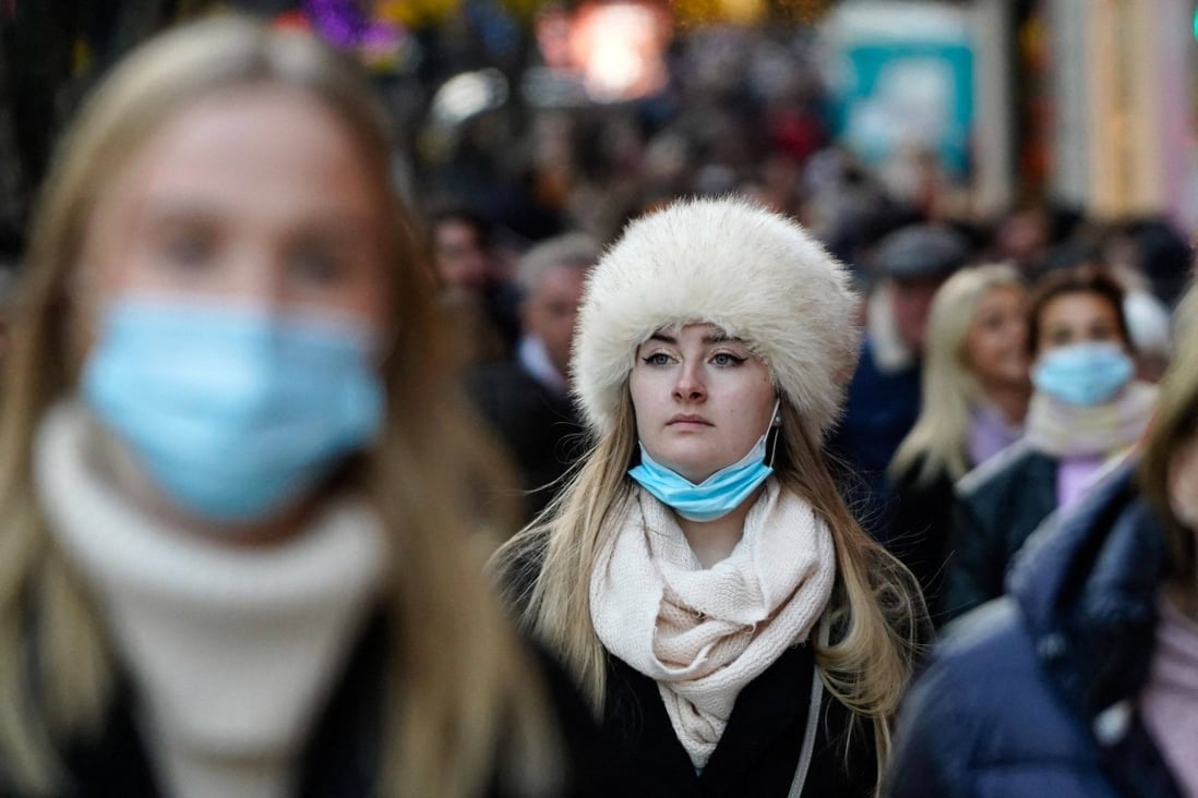 Shoppers, some wearing face coverings, in central London. Prime Minister Boris Johnson warned that Britain faces a ‘tidal wave’ of infections from the Omicron coronavirus variant. Photo: Reuters