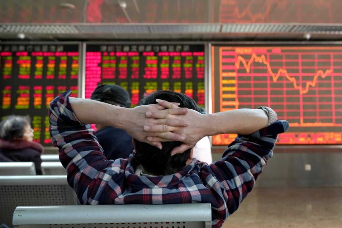 An investor looks at a stock quotation board at a brokerage office in Beijing. Photo: Reuters
