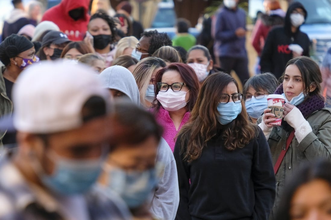 Shoppers wearing face masks wait in line to enter a store in Commerce, California, in November. Photo: AP