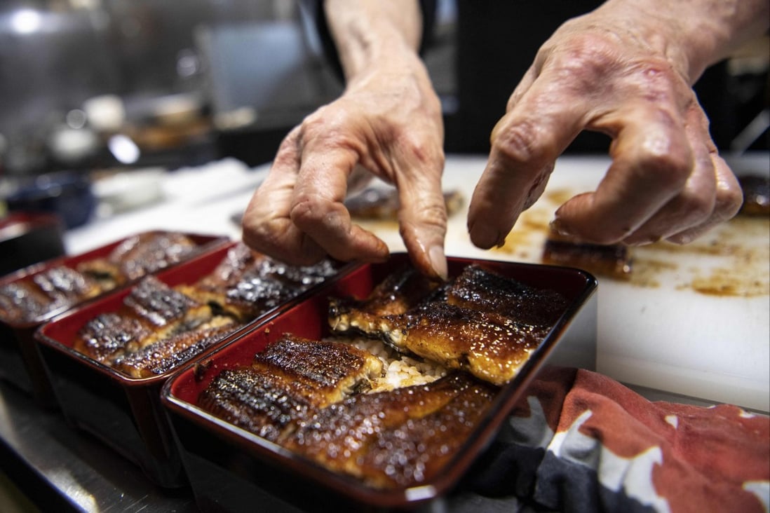 Japanese chef Tsuyoshi Hachisuka prepares grilled eel at his restaurant in Hamamatsu, Shizuoka prefecture, Japan. Shrinking Japanese eel stocks have helped fuel a lucrative black market for the delicacy. Photo: AFP
