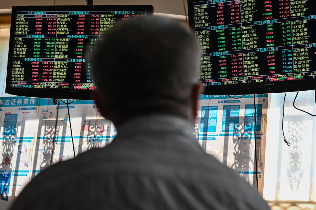 An investor monitors stock price movements at a securities company in Shanghai on September 24. Chinese stocks are attractively priced compared to those in the US, but there are still reasons to be cautious. Photo: AFP