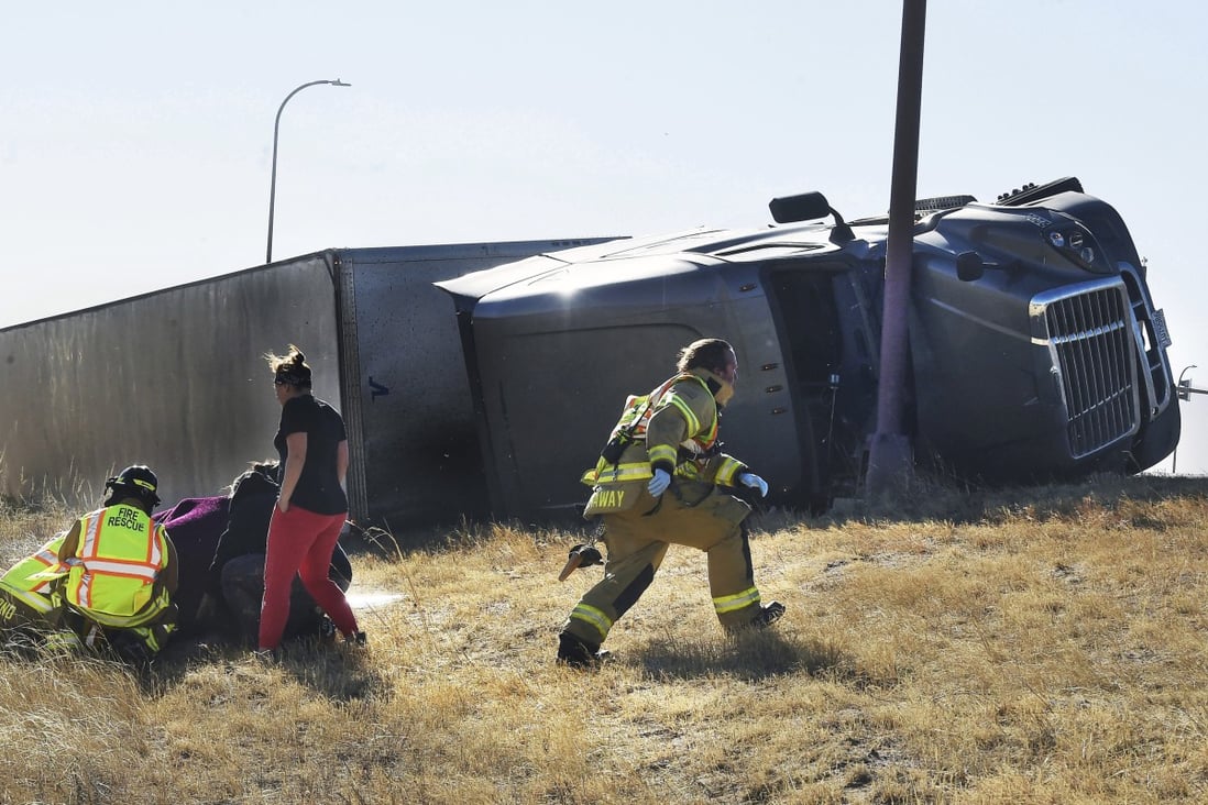 Paramedics tend to an injured person in Colorado Springs, Colorado, on Wednesday. Over a dozen large trucks were blown over by high winds in region. Photo: The Gazette via AP