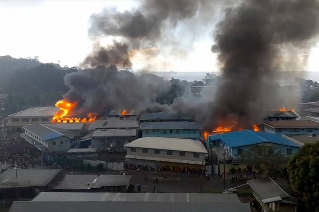 Parts of the Chinatown district in Honiara were ablaze after rioters torched buildings in the Solomon Islands capital on November 25 during anti-government protests. Photo: AFP