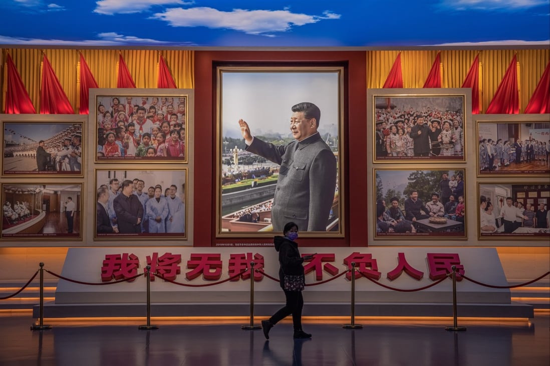 A visitor walks in front of pictures of Chinese President Xi Jinping at the Museum of the Communist Party of China in Beijing on November 23. Photo: EPA-EFE