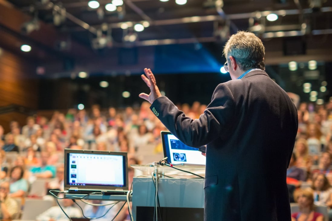 A presenter addresses a busy lecture hall, though in the era of Covid-19, even courses at master’s level and above have been forced to embrace online learning. Photo: Shutterstock
