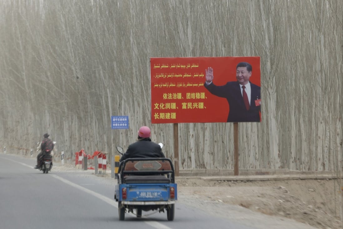 Chinese President Xi Jinping is seen on a billboard with the slogan, “Administer Xinjiang according to law, unite and stabilize the territory, culturally moisturize the territory, enrich the people and rejuvenate the territory, and build the territory for a long term,” in Yarkent County in northwestern China’s Xinjiang Uyghur Autonomous Region in March 2021. Photo: AP