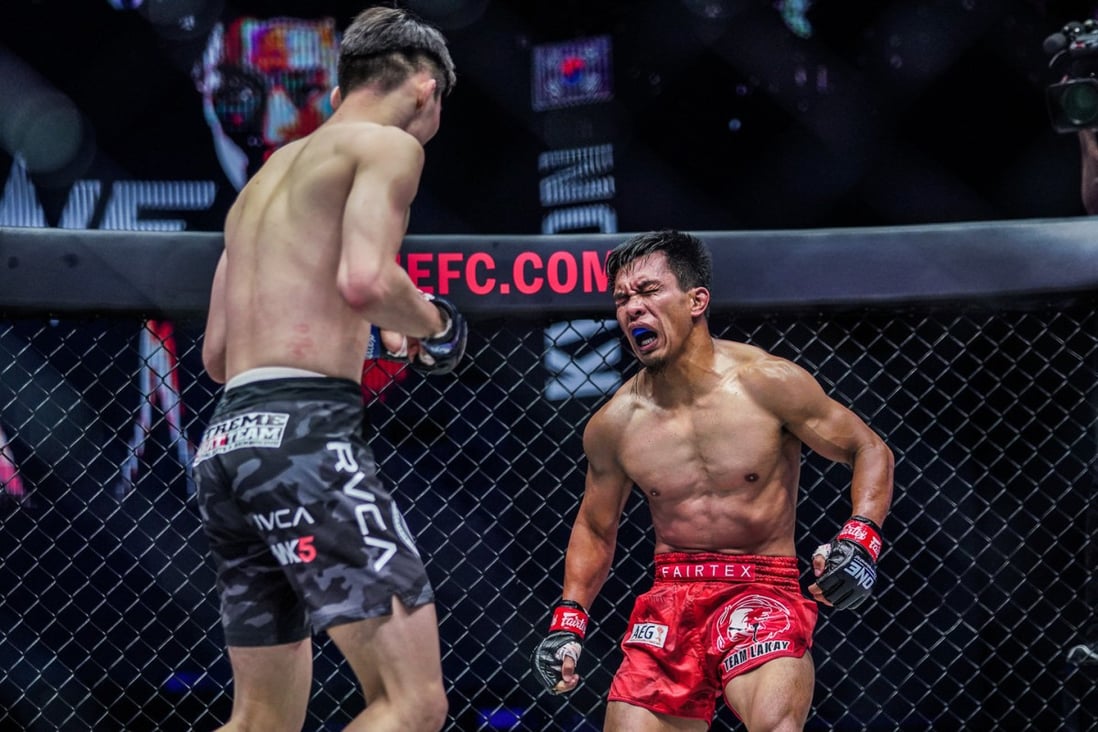 Kevin Belingon winces in pain as he falls to the floor after a fight-ending liver shot by Kwon Won-il. Photos: Ryan Peters/ONE Championship