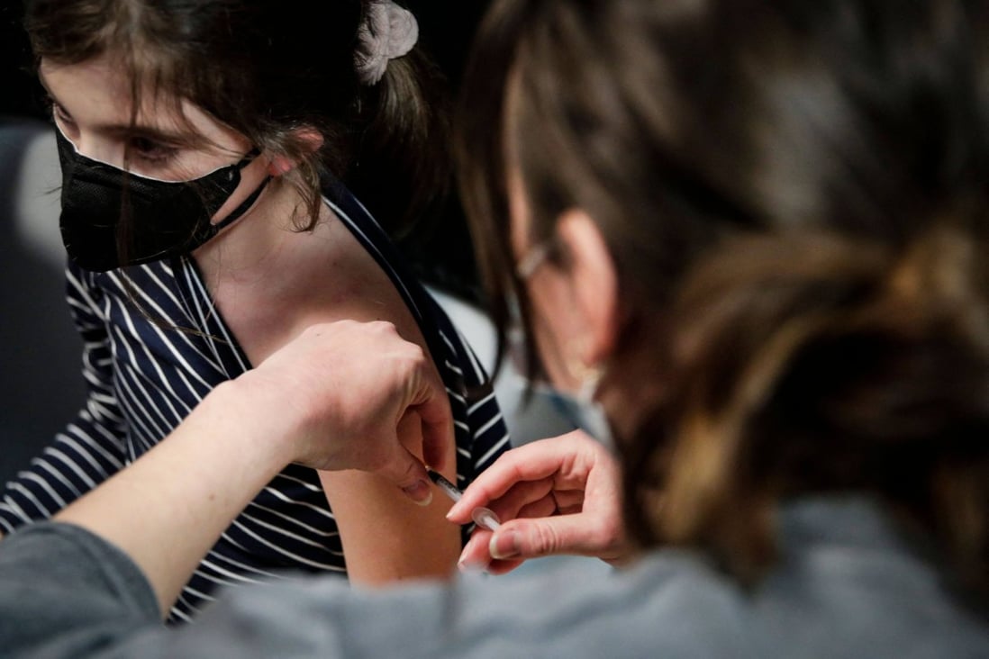 A girl receives a dose of the Pfizer/BioNTech vaccine in Paris, France. Vaccination against Covid-19 will be proposed to children aged 5 to 11 years from December 22 “if all goes well”, said French Minister of Health Olivier Veran. Photo: AFP