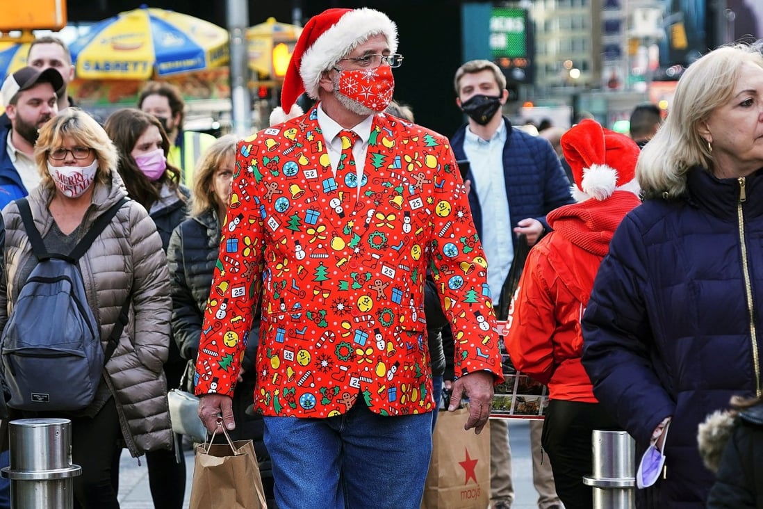 A man wearing a festive attire and a mask walks through Times Square in New York on Friday. Photo: Reuters
