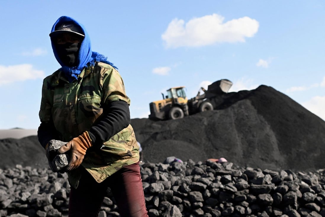 A worker sorts coal near a mine in Datong, in China’s northern Shanxi province, on November 3. Many rural areas rely on coal as their only source of power. Photo: AFP