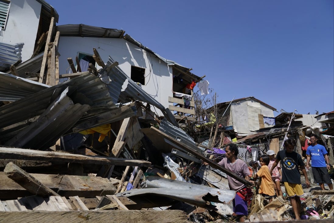 Residents salvage parts of their homes damaged due to Typhoon Rai in Talisay, Cebu province, central Philippines. Photo: AP