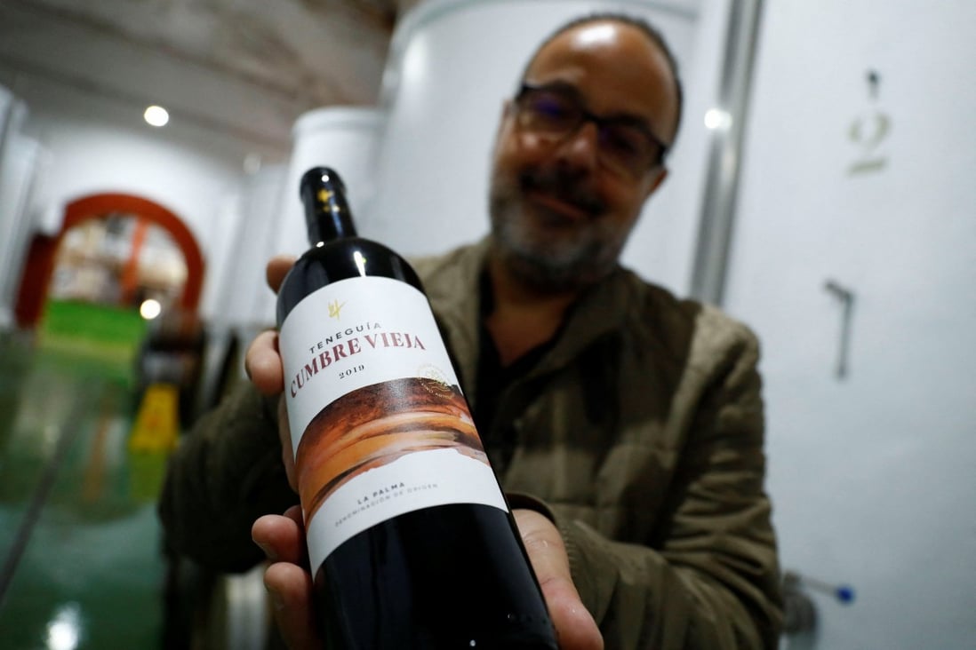 Carlos Lozano, winemaker, shows a bottle of Cumbre Vieja wine, in Fuencaliente, La Palma, Spain. His cellar has exhausted the production of wine that bears the same name as the Cumbre Vieja volcano. Photo: Reuters