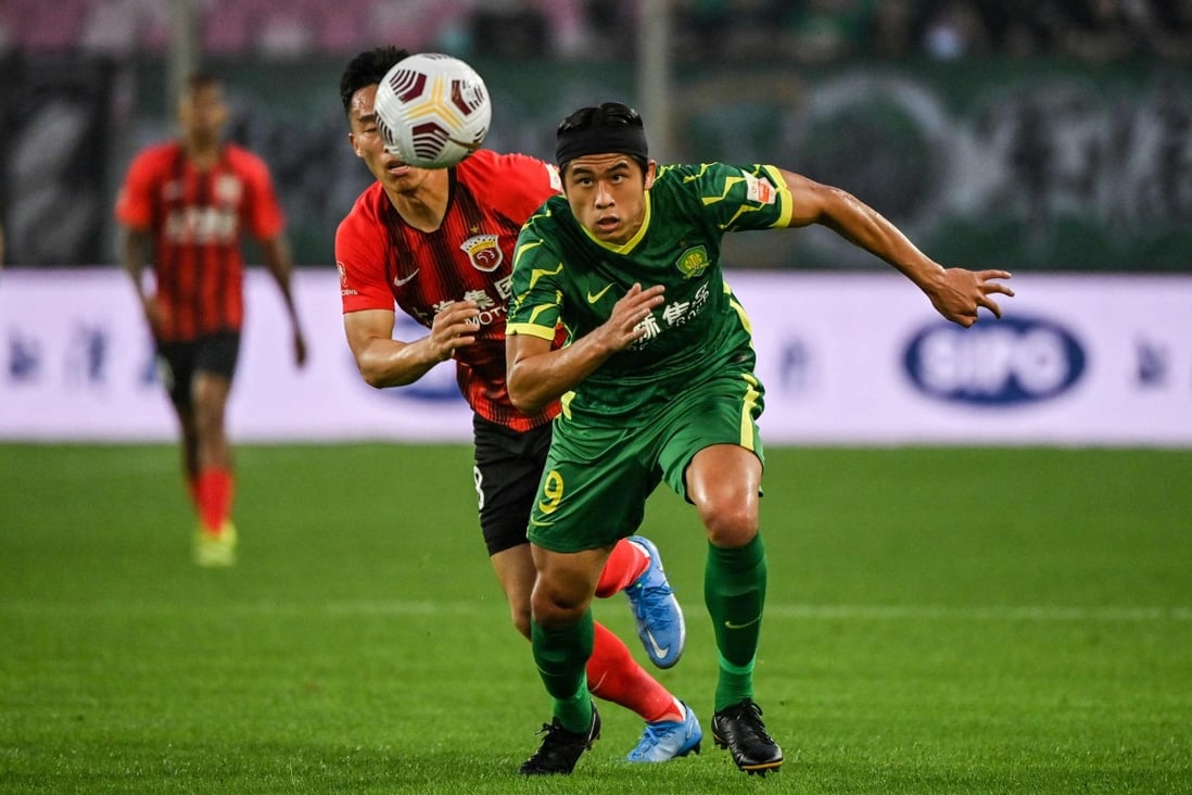 Shanghai Port’s He Guan (left) and Beijing Guoan’s Zhang Yuning compete for the ball during the Chinese Super League.  Photo: AFP
