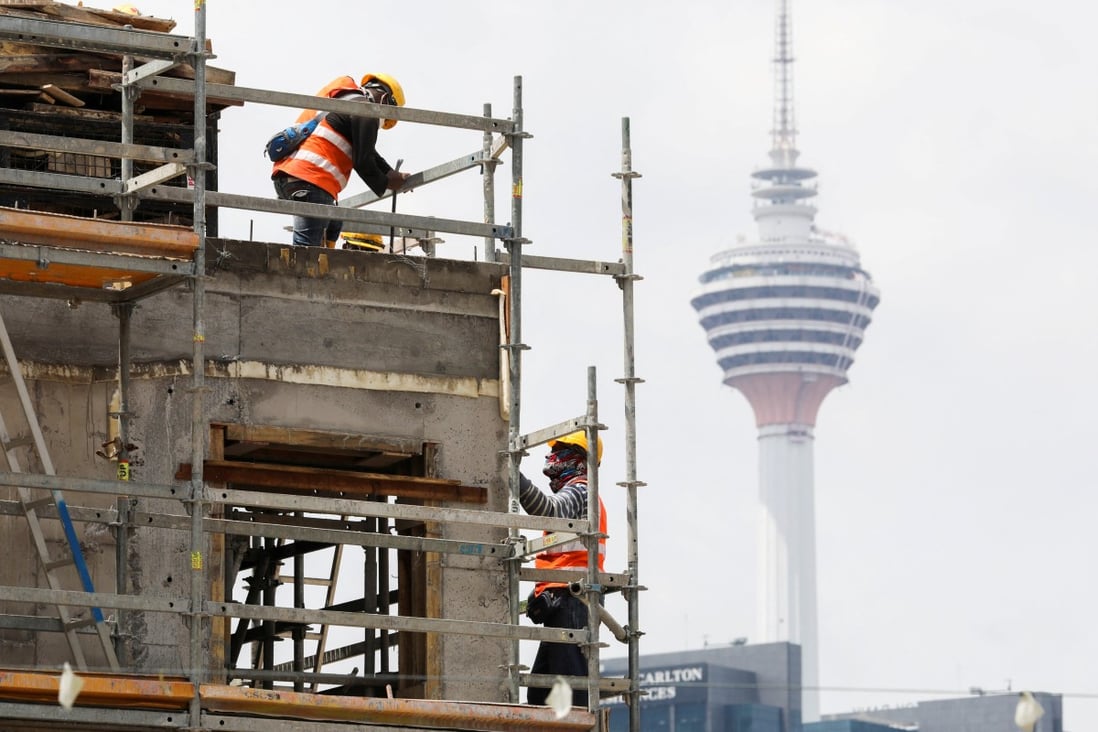 Labourers work at a construction site in Kuala Lumpur, Malaysia. Photo: Reuters