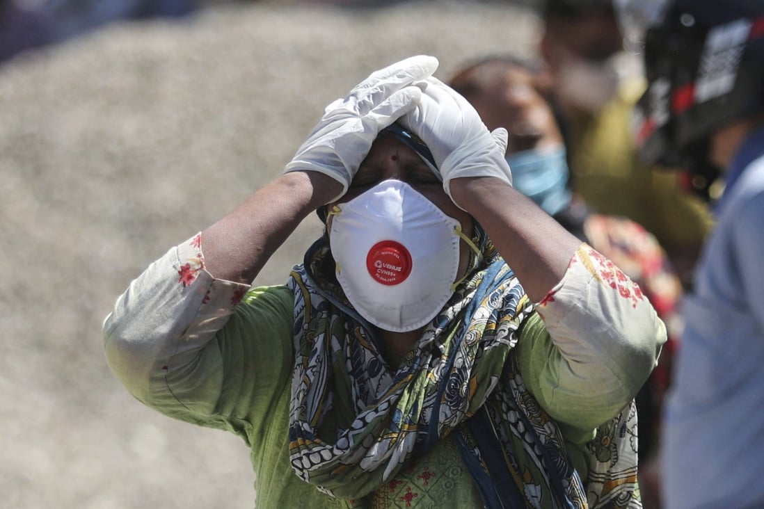 A relative of a person who died of Covid-19 reacts at a crematorium in Jammu, India, in April 2021. 
The nation’s leader, Narendra Modi, has been the focus of a huge advertising blitz touting his government’s successes in fighting the pandemic despite almost 500,000 Indians dying from the virus. Photo: AP
