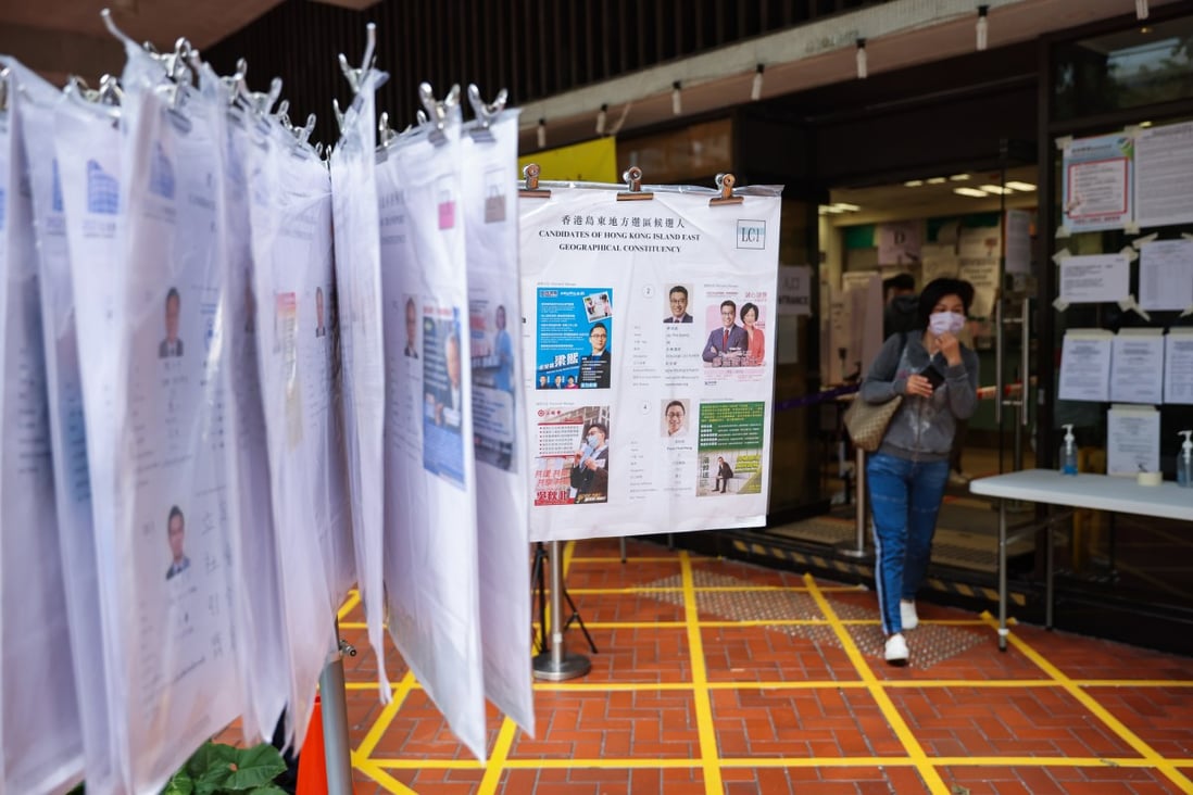 A woman leaves a polling station in Taikoo Shing during the 2021 Legislative Council election on Sunday. Photo: Nora Tam