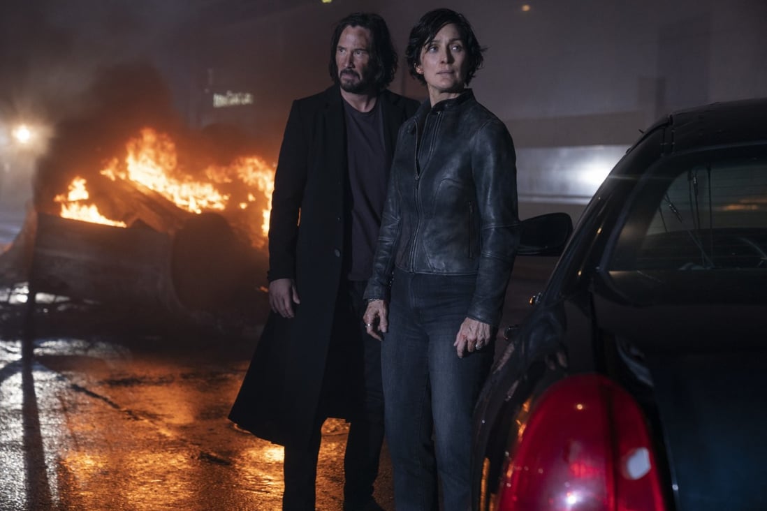 Keanu Reeves (left) and Carrie Anne Moss in a scene from The Matrix Resurrections (category: IIB), directed by Lana Wachowski and co-starring Jessica Henwick.