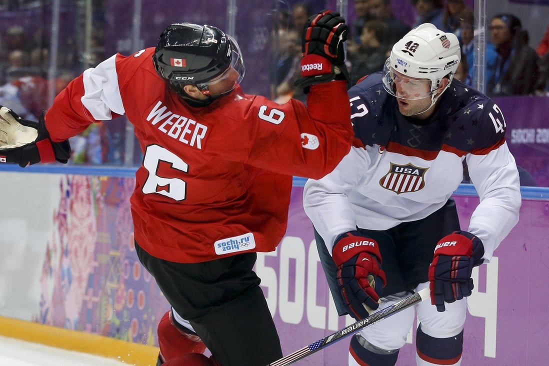 Canada’s Shea Weber, trips over USA forward David Backes during the third period of a men’s semifinal hockey game at the 2014 Winter Olympics in Sochi, Russia. NHL players will not take part in the upcoming Winter Olympics in Beijing. Photo: AP