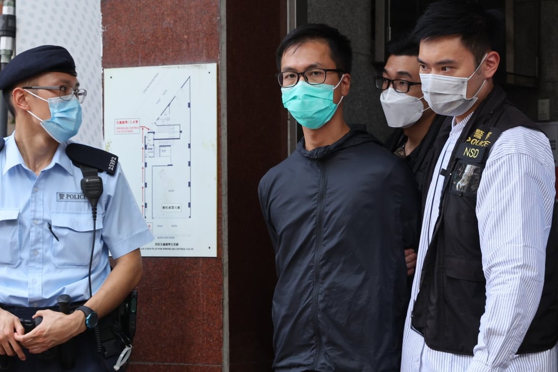Simon Leung is escorted by police officers during a raid on the June 4 museum in September. Photo: May Tse