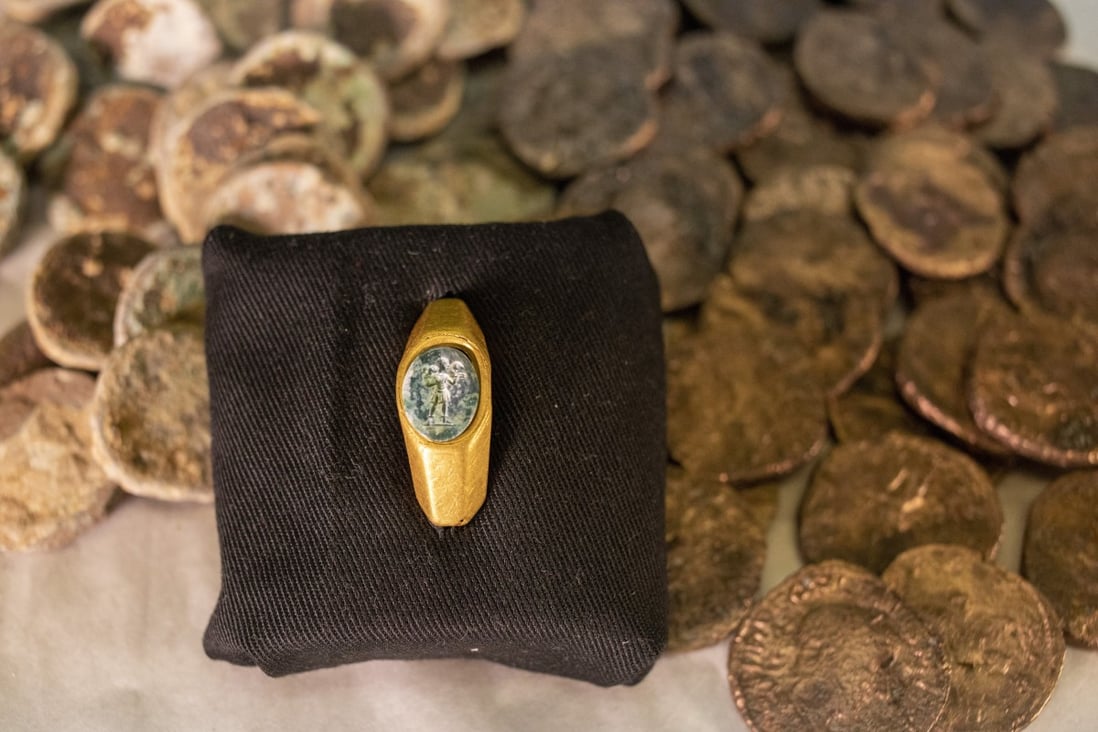 A Roman gold ring, its green gemstone carved with the figure of a shepherd carrying a sheep on his shoulders. Photo: AP