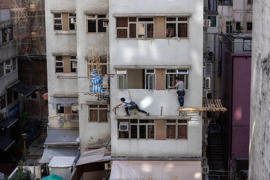 Workers dismantle bamboo scaffolding on a block of flats in Hong Kong on December 8. Hong Kong must increase its supply of affordable housing, as it is clear the central government is serious about the city “bidding farewell” to subdivided flats and cage homes. Photo: EPA-EFE