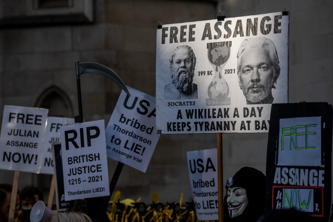 Supporters of Julian Assange gather outside the Royal Courts of Justice in London on December 10. Photo: TNS