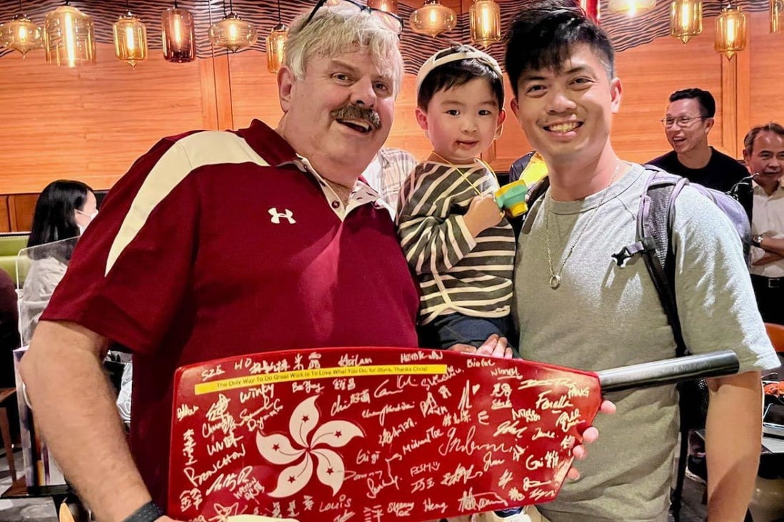 Chris Perry receives a gift of a oar blade in Hong Kong colours, signed by people he worked with during his 36 years as head rowing coach. Photo: Handout